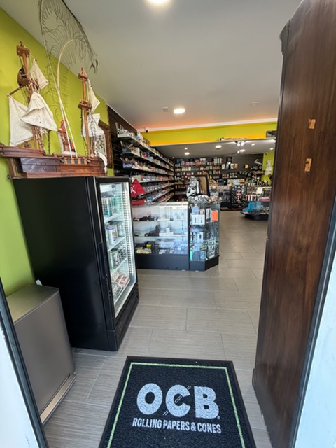 Entrance to Pirate's Bay Smoke Shop featuring a model pirate ship