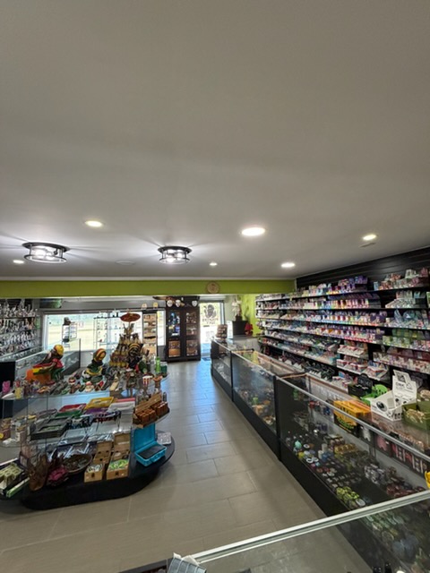 Inside Pirate's Bay Smoke Shop — packed shelves of vapes and accessories